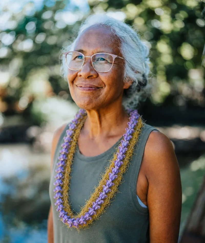 Hawaiian Woman with Lei 2 Kūpuna smiling and wearing a beautiful flower crown lei.