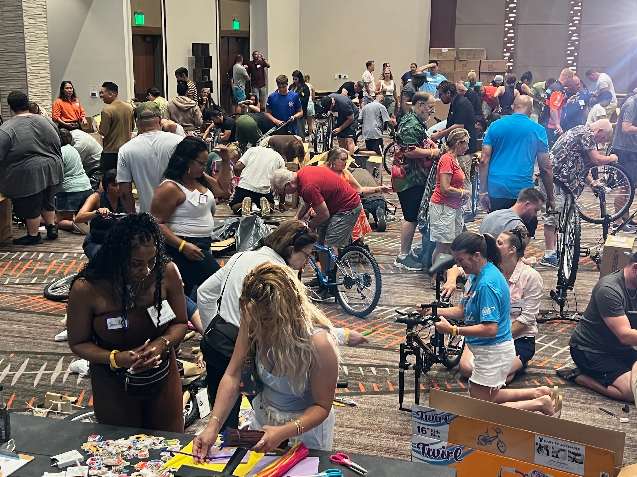 many people building bikes in a convention hall