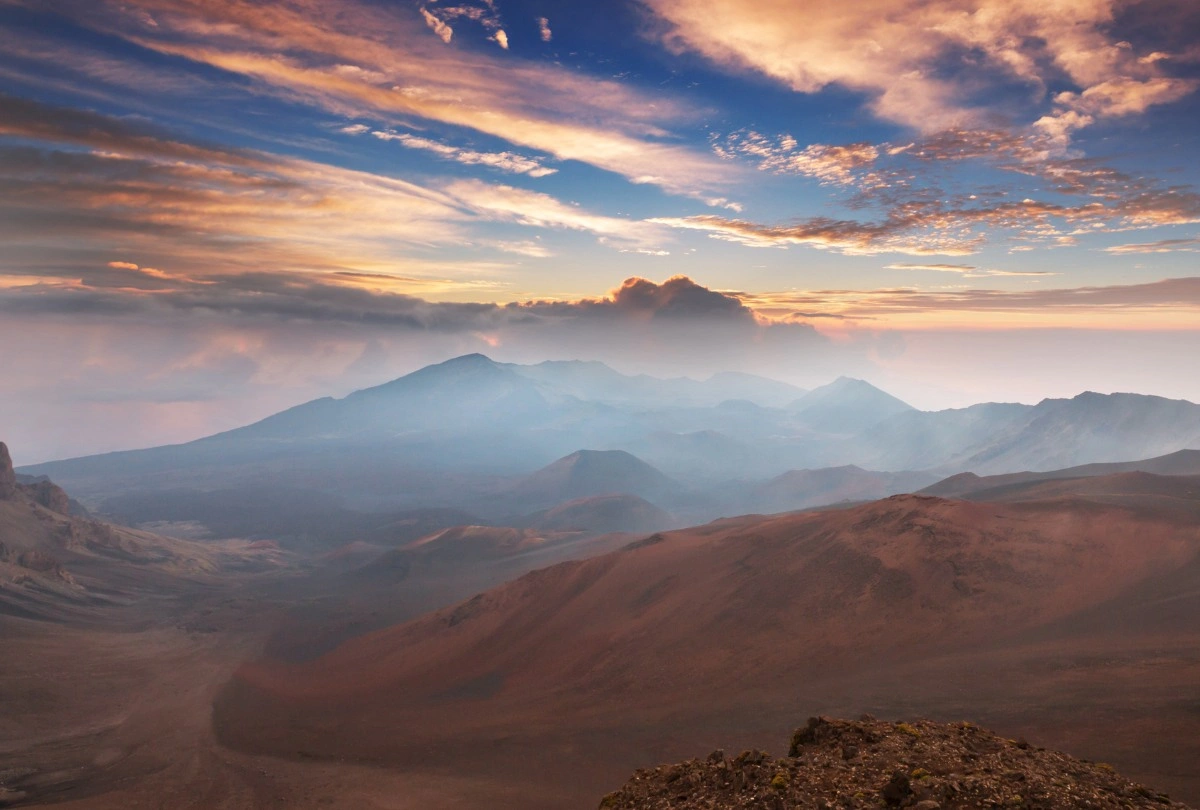 haleakala sunrise Sunrise over Haleakalā Crater with colorful clouds and mountain ridges.