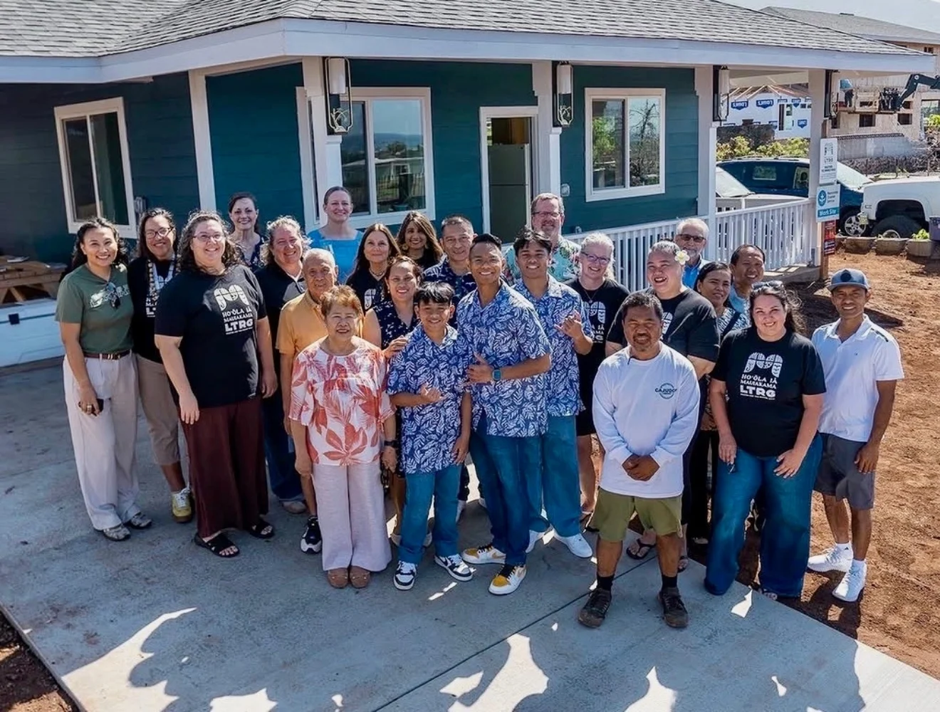 The Yadao family stands together outside their rebuilt home in Lāhainā after returning home following the 2023 Maui wildfires.
